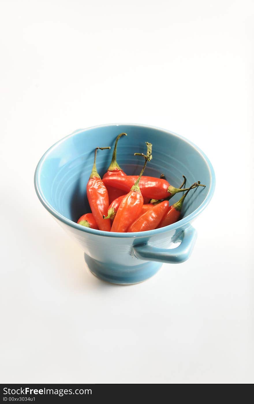 Bowl with a bunch of red hot chili peppers - isolated. Bowl with a bunch of red hot chili peppers - isolated