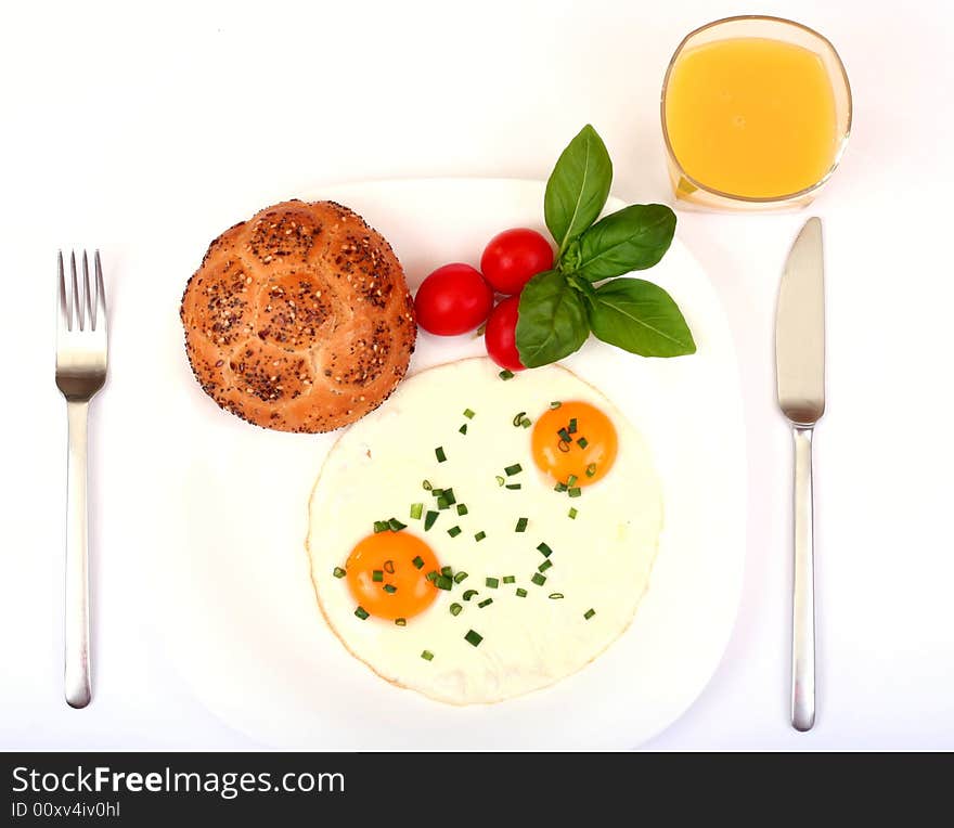 Breakfast with fried eggs, tomatoes and orange juice and fork isolated. Breakfast with fried eggs, tomatoes and orange juice and fork isolated