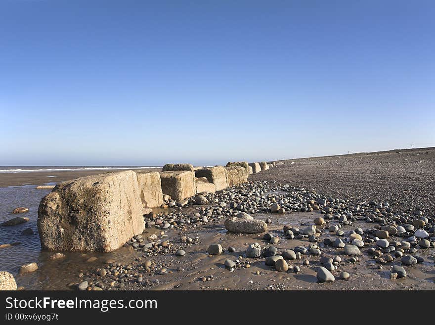 World War II tank block defences in 2008 on beach in East Yorkshire, England