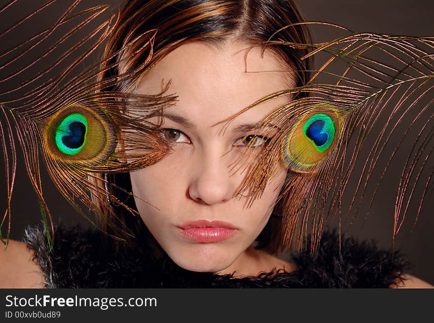 Portrait of fashion woman holding peacock feathers. Portrait of fashion woman holding peacock feathers