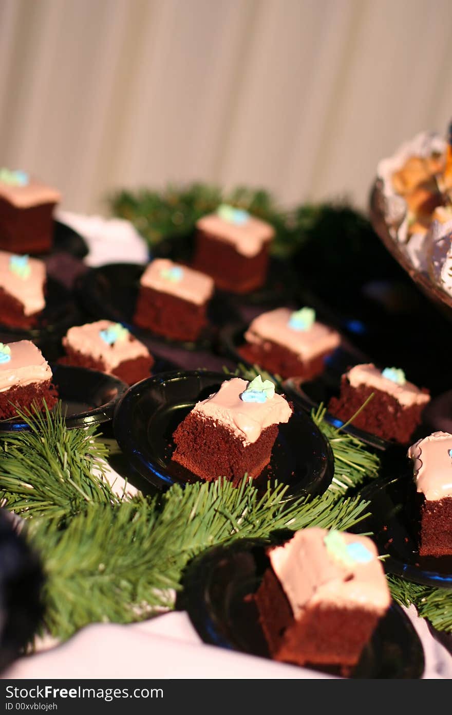 Close up of multiple pieces of chocolate cake on tiny plates