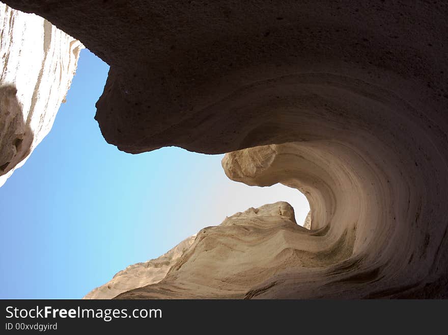 Upward shot through a slot canyon at Tent Rocks national monument, New Mexico.  The bottom of the canyon here is about six feet wide. Upward shot through a slot canyon at Tent Rocks national monument, New Mexico.  The bottom of the canyon here is about six feet wide.