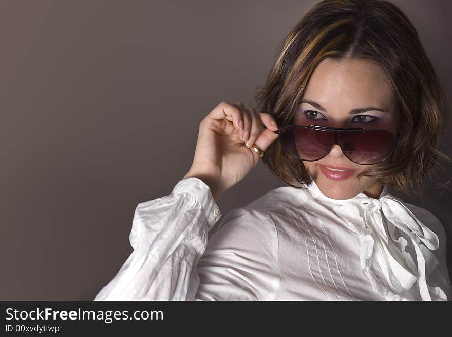 Portrait of fashion female wearing sunglasses with seductive smile. Portrait of fashion female wearing sunglasses with seductive smile