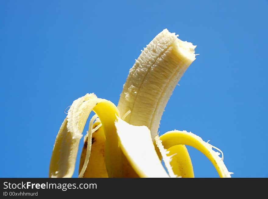 Detail of ripe fresh banana fruit against blue background