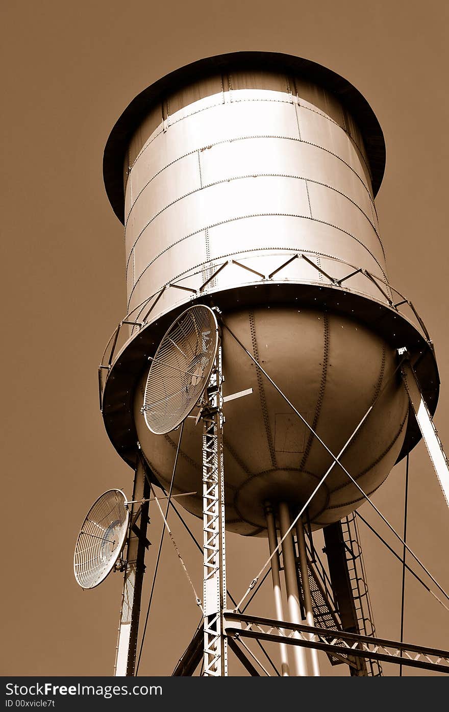 Two Telecommunication Microwaves Mounted on Water Tank. Two Telecommunication Microwaves Mounted on Water Tank