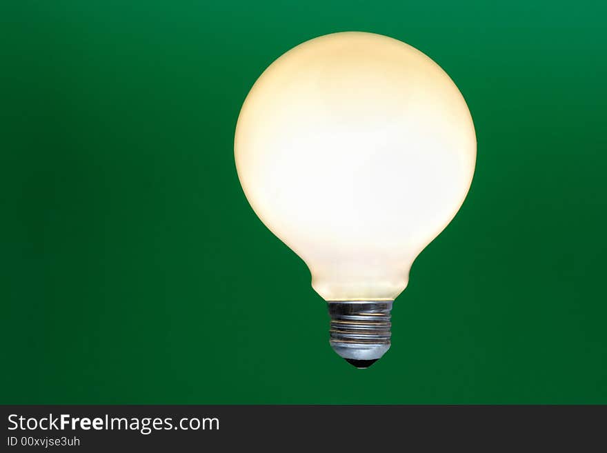 Light bulb on a green