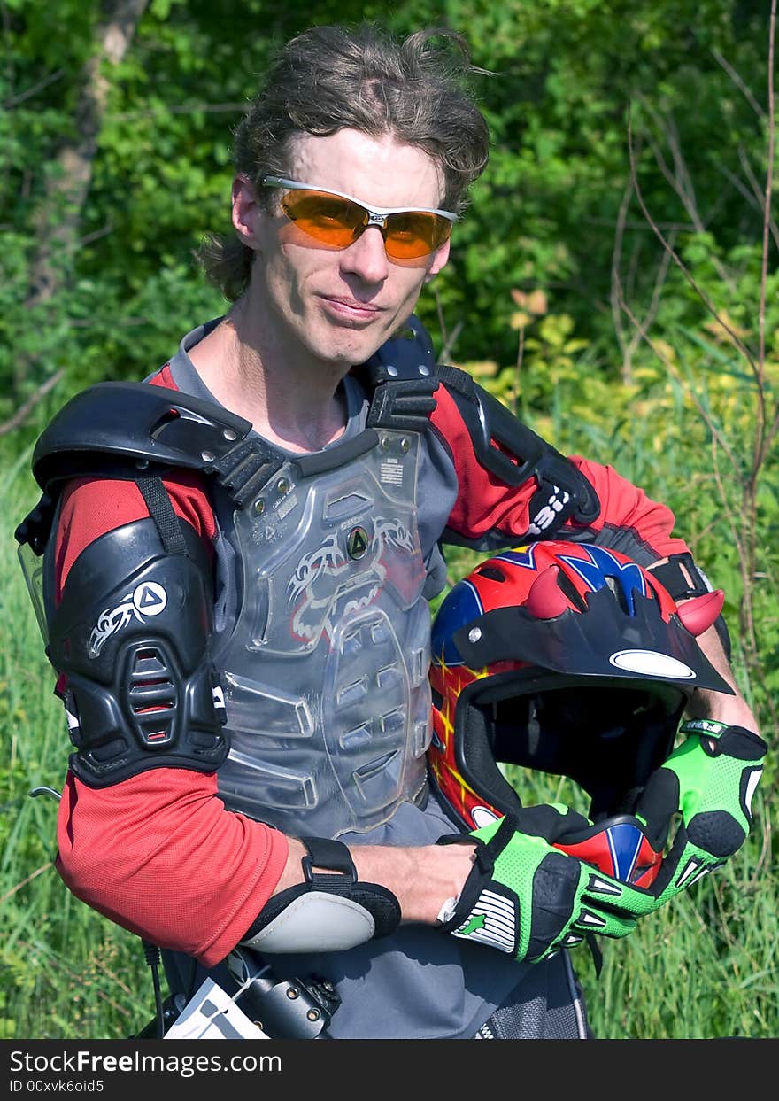 Portrait of downhill rider holding the helmet. Portrait of downhill rider holding the helmet