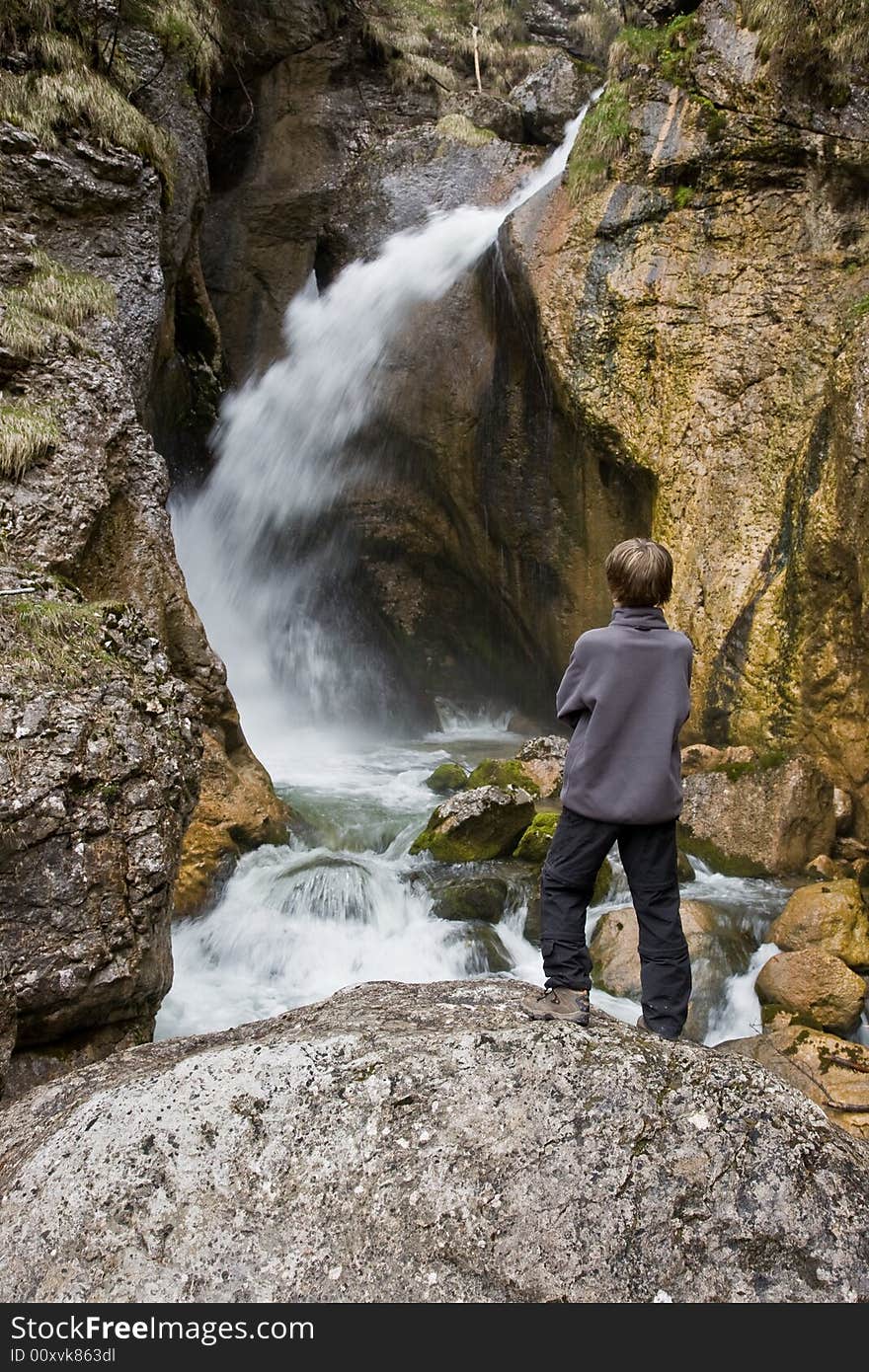 Boy watching the waterfall