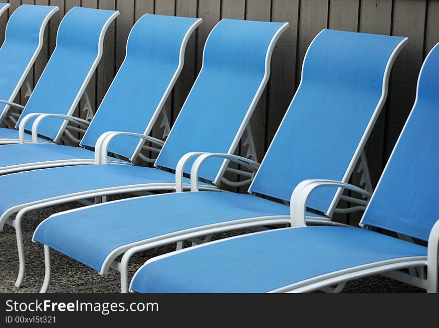 Row of new pool chaise lounges. Row of new pool chaise lounges.