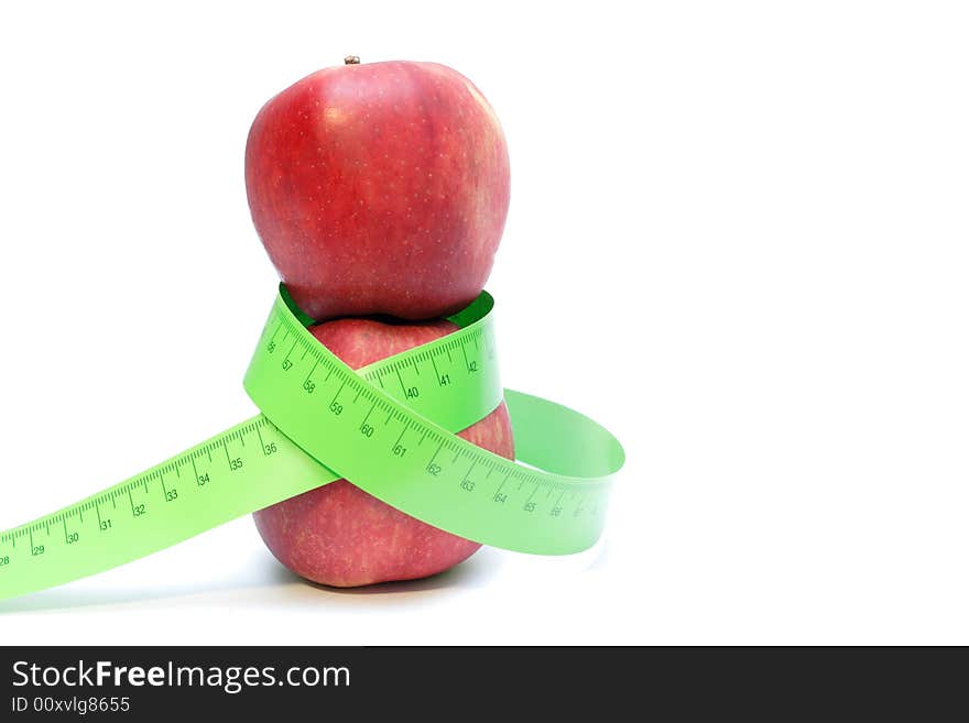 Close-up of a red apples with a measuring tape around it. Close-up of a red apples with a measuring tape around it.