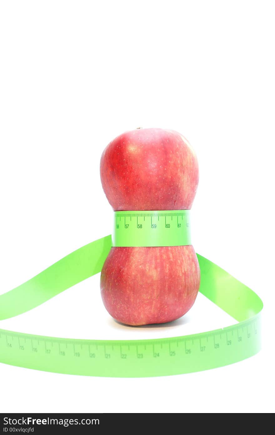 Close-up of a red apples with a measuring tape around it. Close-up of a red apples with a measuring tape around it.