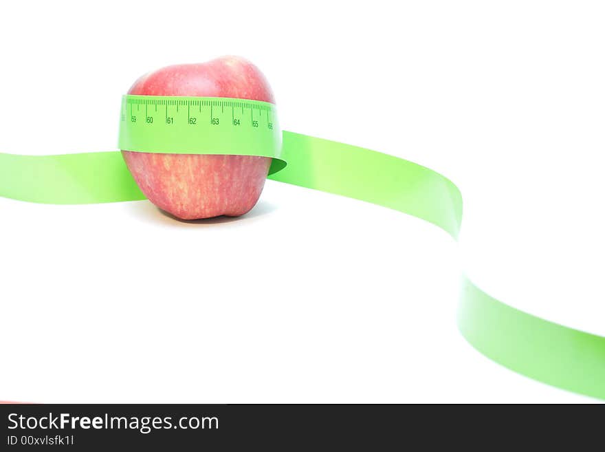 Red apple wrapped in a measuring tape