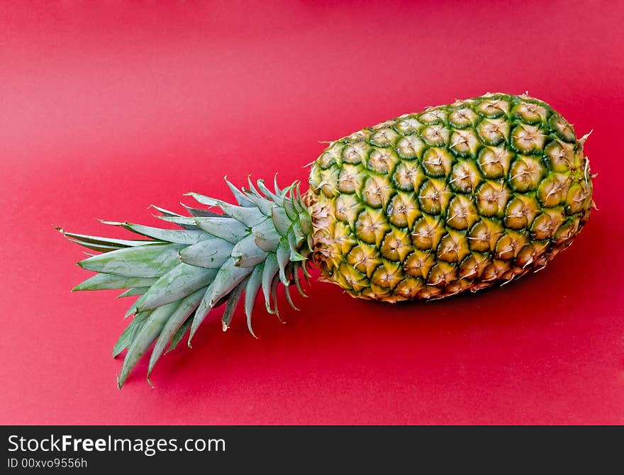 Pineapple on red.close up