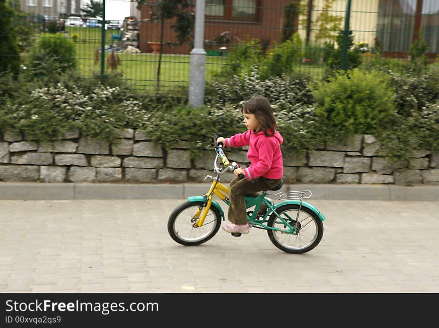 Little girl riding his bike