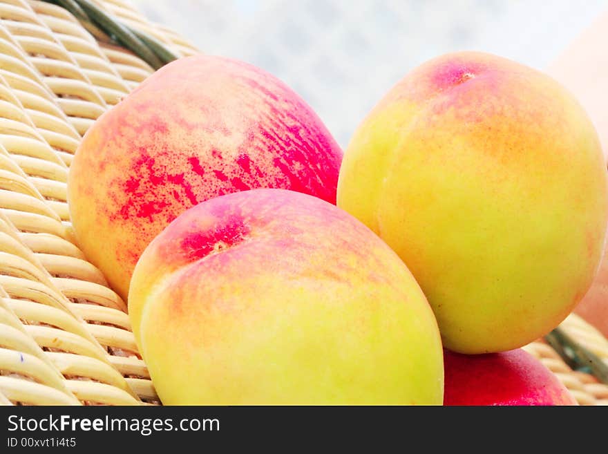 The fresh peach with white background on a cane chair. The fresh peach with white background on a cane chair