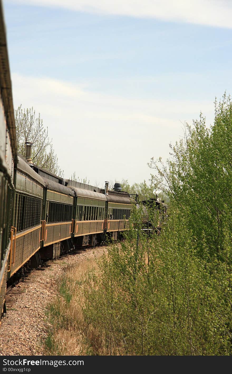 A restored Steam Engine pulling passenger cars through the Canadian Prairies. A restored Steam Engine pulling passenger cars through the Canadian Prairies