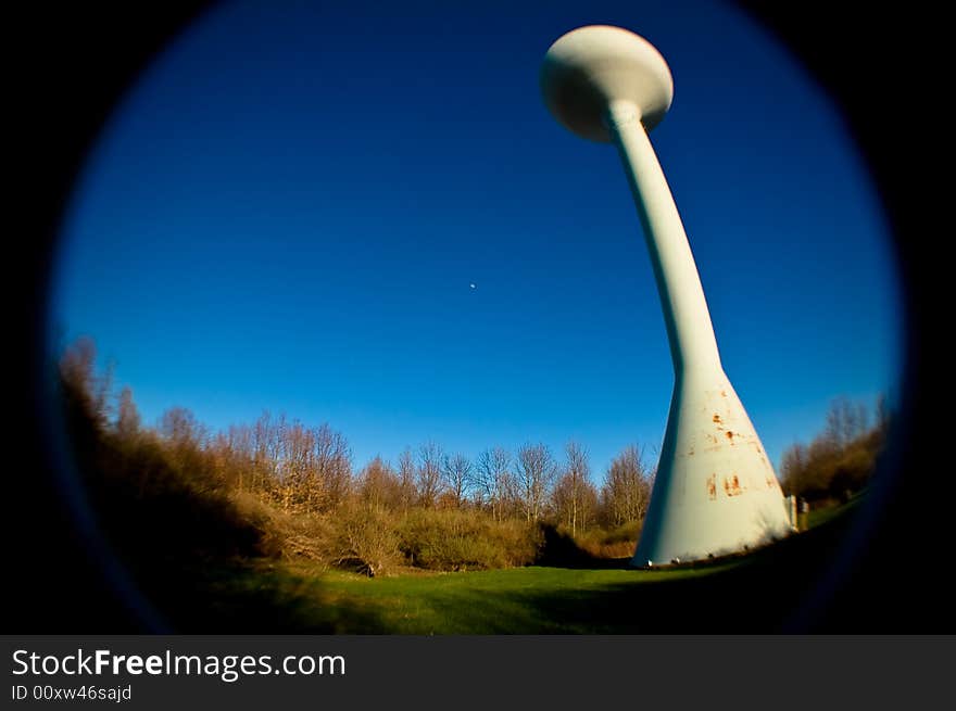 Water tower shot with fisheye lens, blue sky and field. Water tower shot with fisheye lens, blue sky and field.