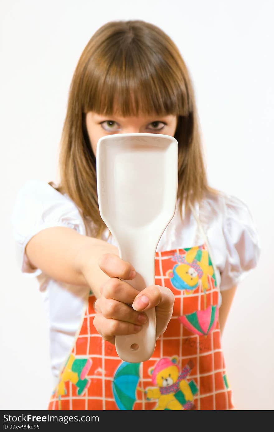 Young girl holding spoon