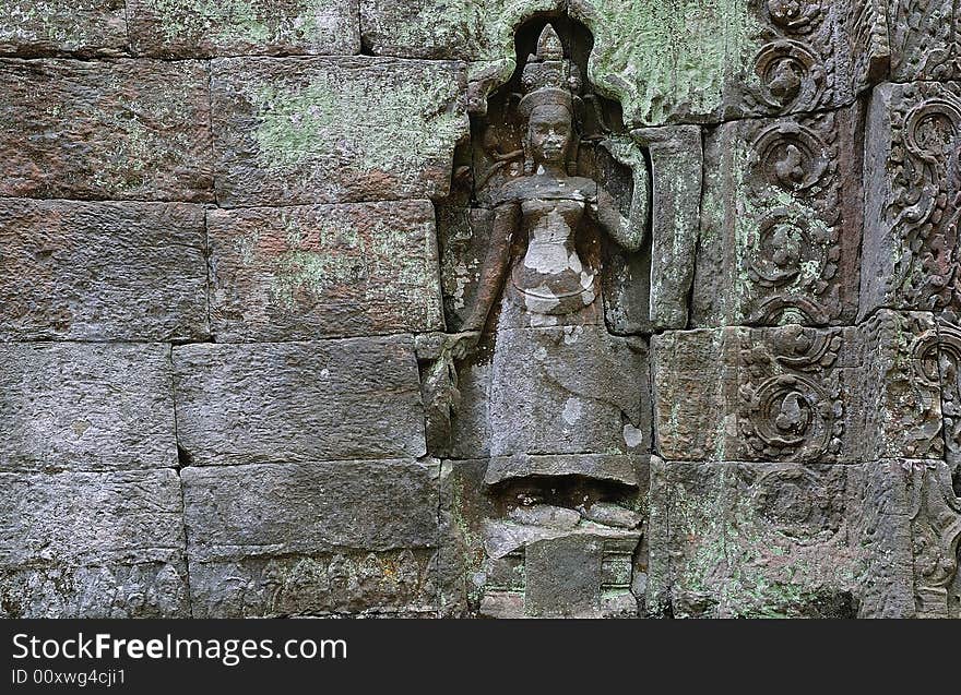 The Ta Prohm is an ancient Mahayana Buddhist monastery and university builted between the 12th and 13th centuries by the Khmer king Jayavarman VII. The walls are decorated with deep bas relief of female divinities, devatas or apsaras. The Ta Prohm is an ancient Mahayana Buddhist monastery and university builted between the 12th and 13th centuries by the Khmer king Jayavarman VII. The walls are decorated with deep bas relief of female divinities, devatas or apsaras.