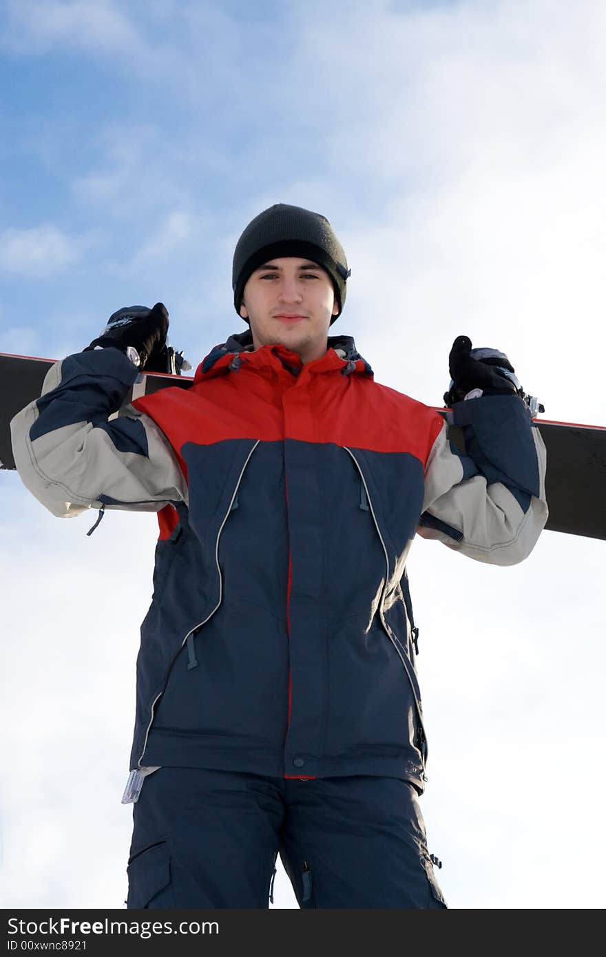 Young snowboarder on a background of the blue sky. Young snowboarder on a background of the blue sky