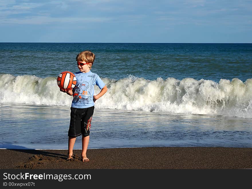 Joyful child play on coast of ocean. Joyful child play on coast of ocean