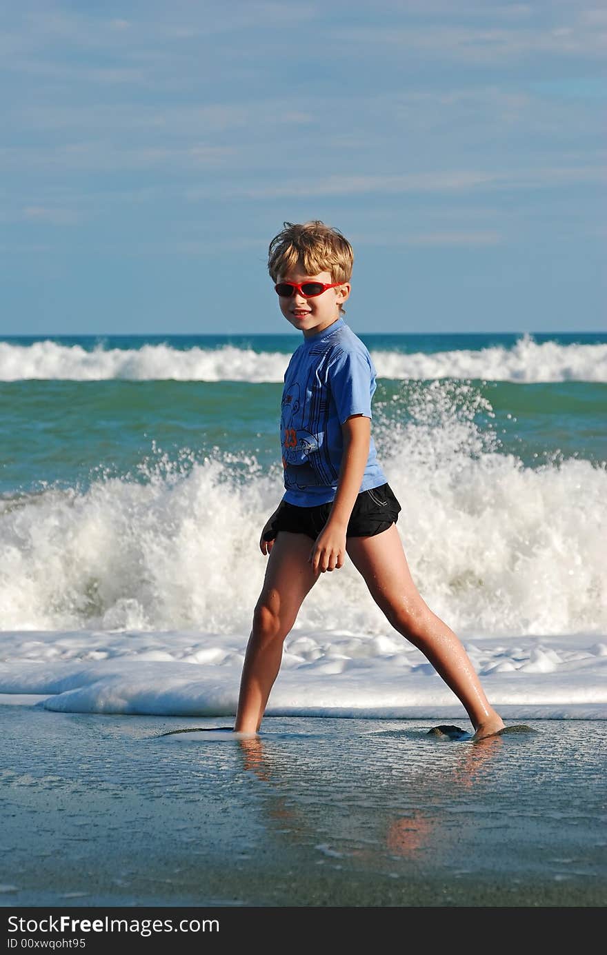 Joyful child play on coast of ocean. Joyful child play on coast of ocean