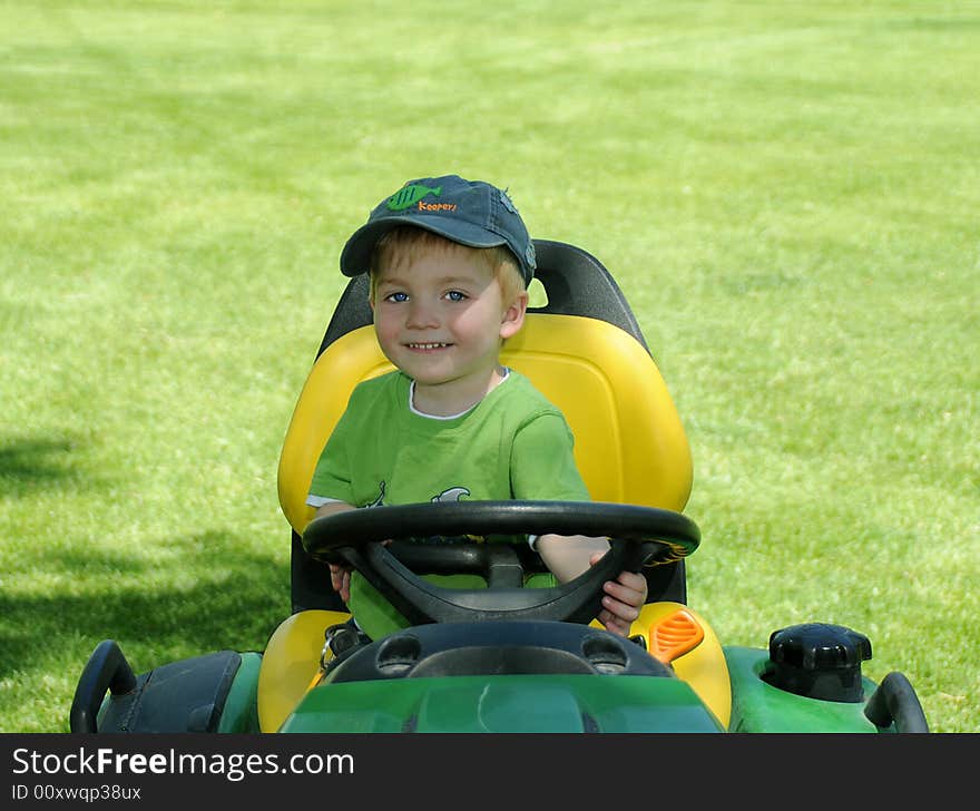 Young Child On Riding Lawnmower