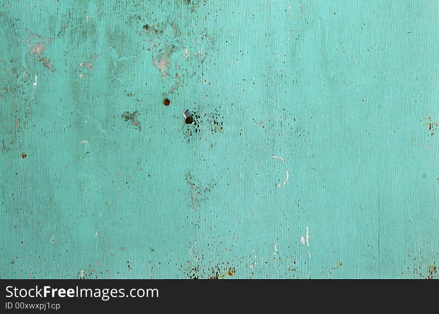 Blue wall texture with peeling paint