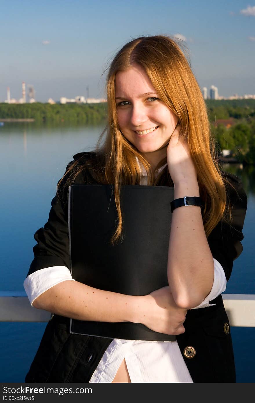 The young attractive businesswoman with a folder. The young attractive businesswoman with a folder