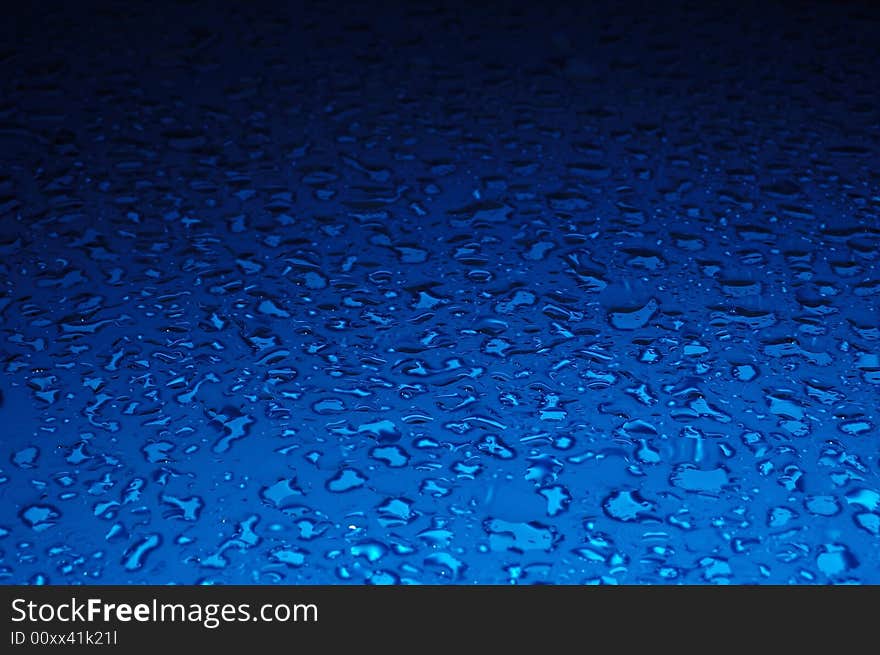 Water drops background texture in blue color