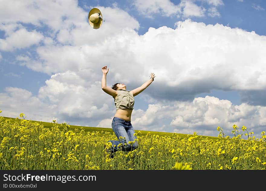 Girl having fun in summer rape field