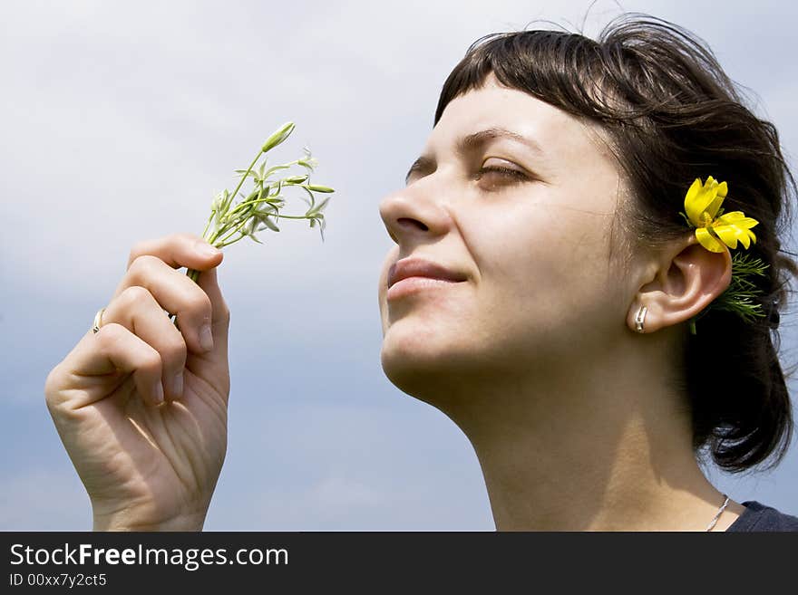 Young girl smelling wild flowers