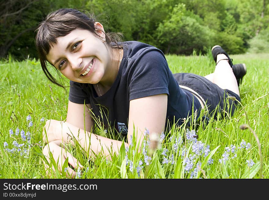 Young girl laying in grass