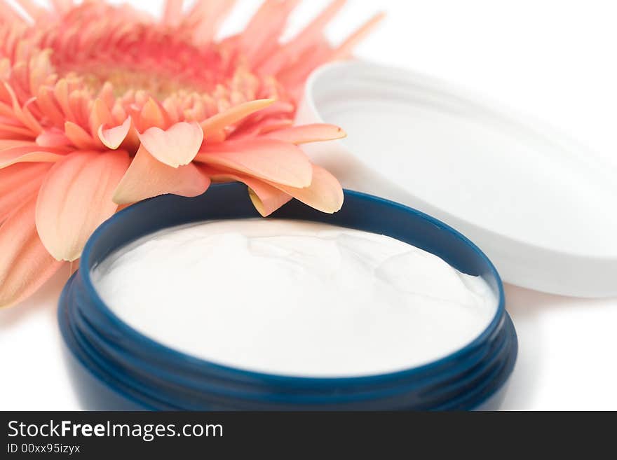 Moisturizing cream with orange gerbera close up