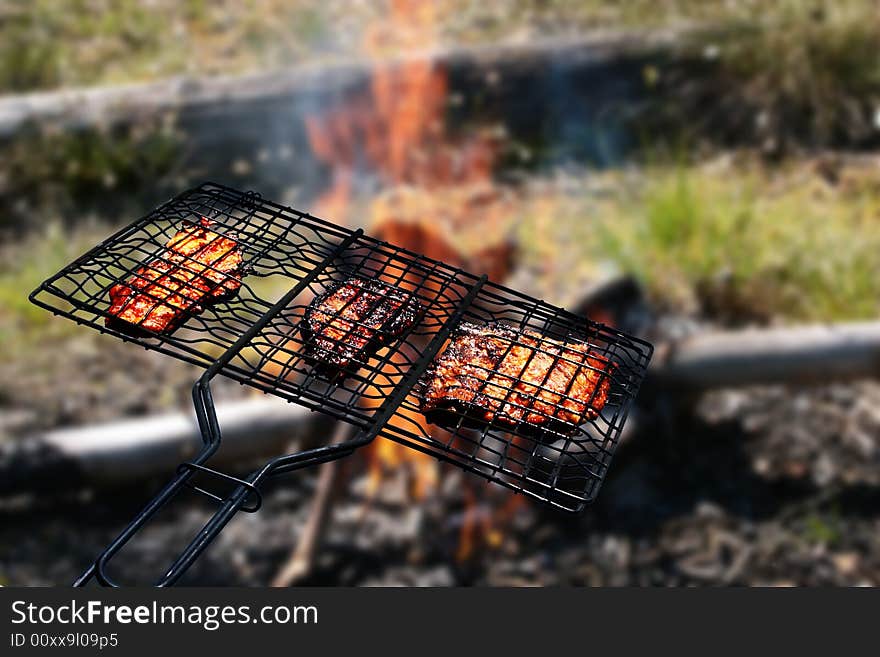Grill concept. Grilled meat. Fire and smoke on the background.