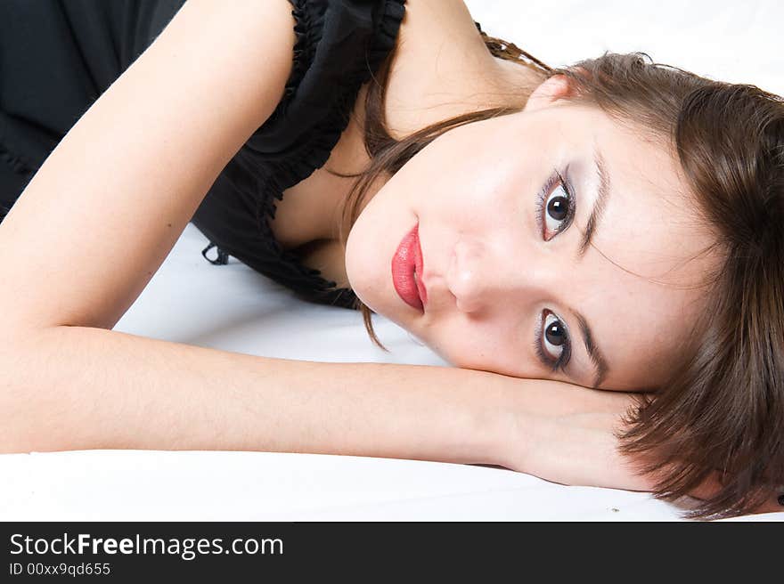 Close-up. Young japanese girl lying on the floor. Beautiful make-up. Isolated