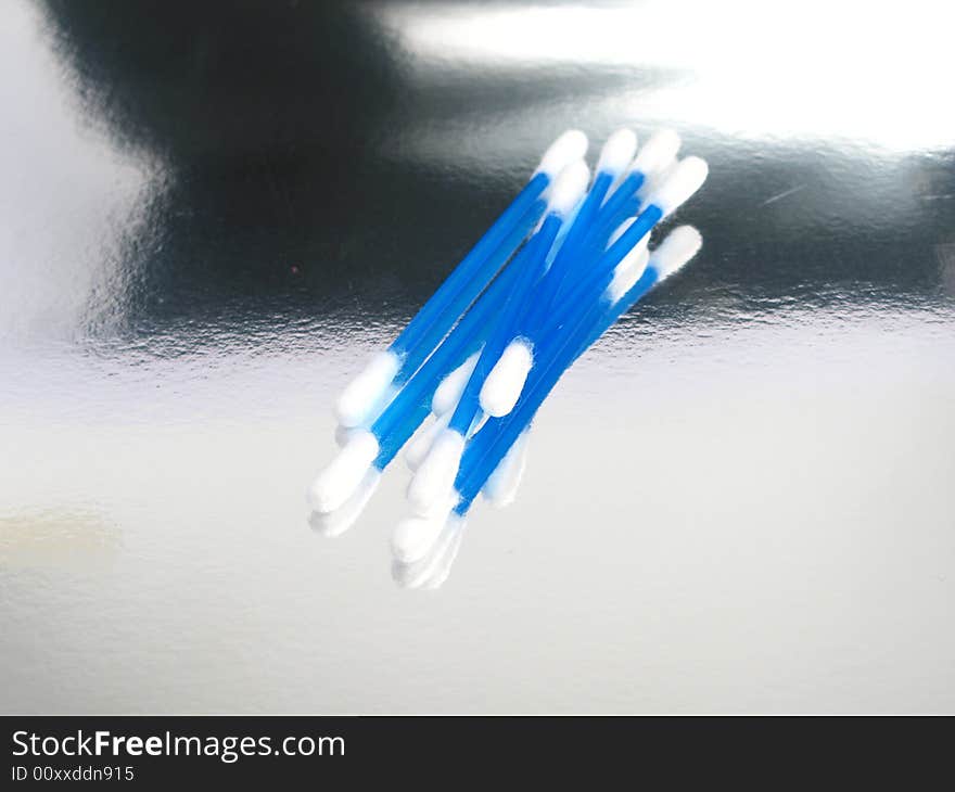 Cotton sticks in a silver background