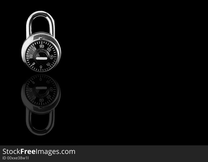 Combination lock against black mirror background. Combination lock against black mirror background.