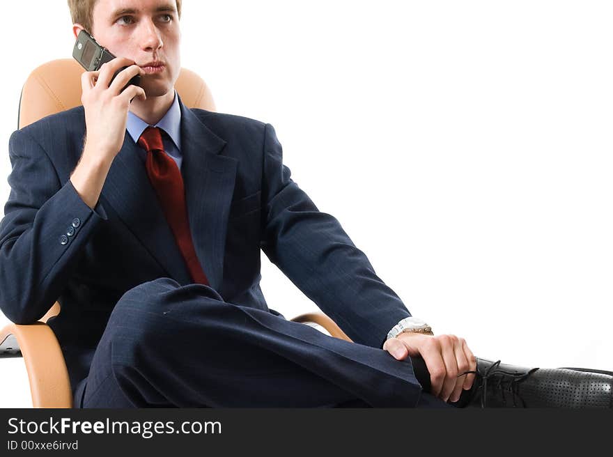 Close-up businessman sitting on an armchair with cell phone. Isolated on white