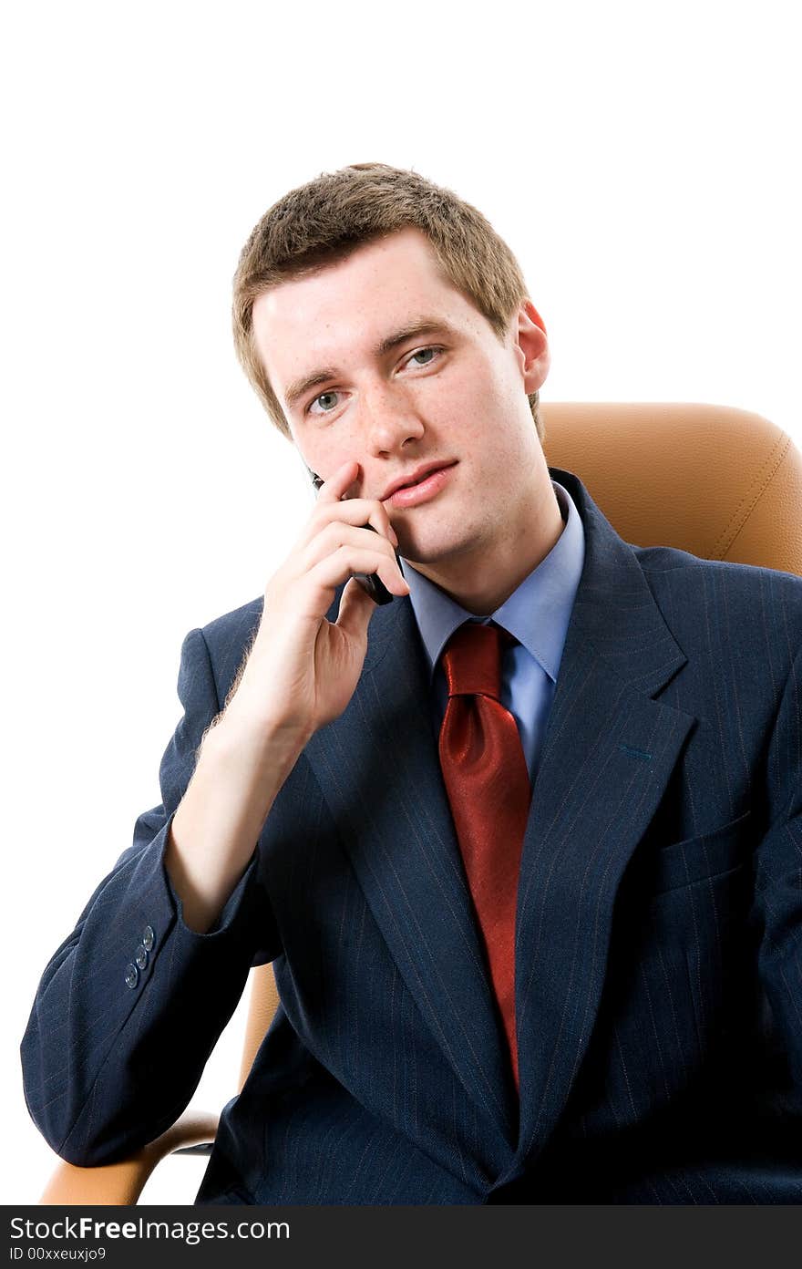 Businessman sitting on an armchair with cell phone. Isolated. Businessman sitting on an armchair with cell phone. Isolated