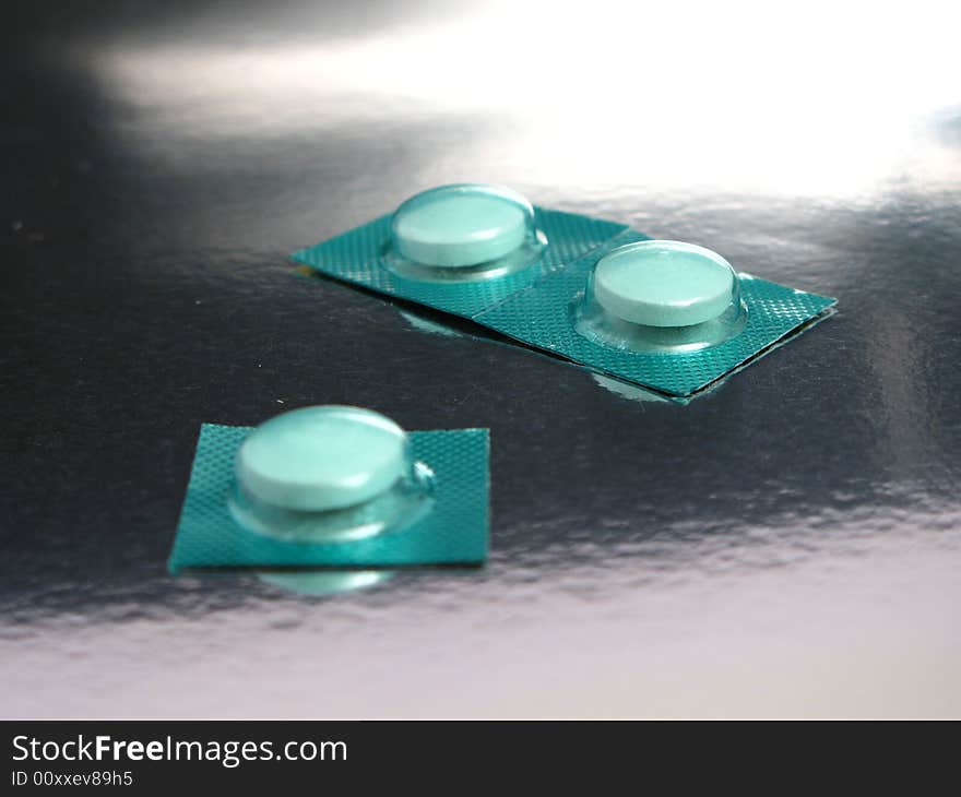 Packed medicines in a silver background