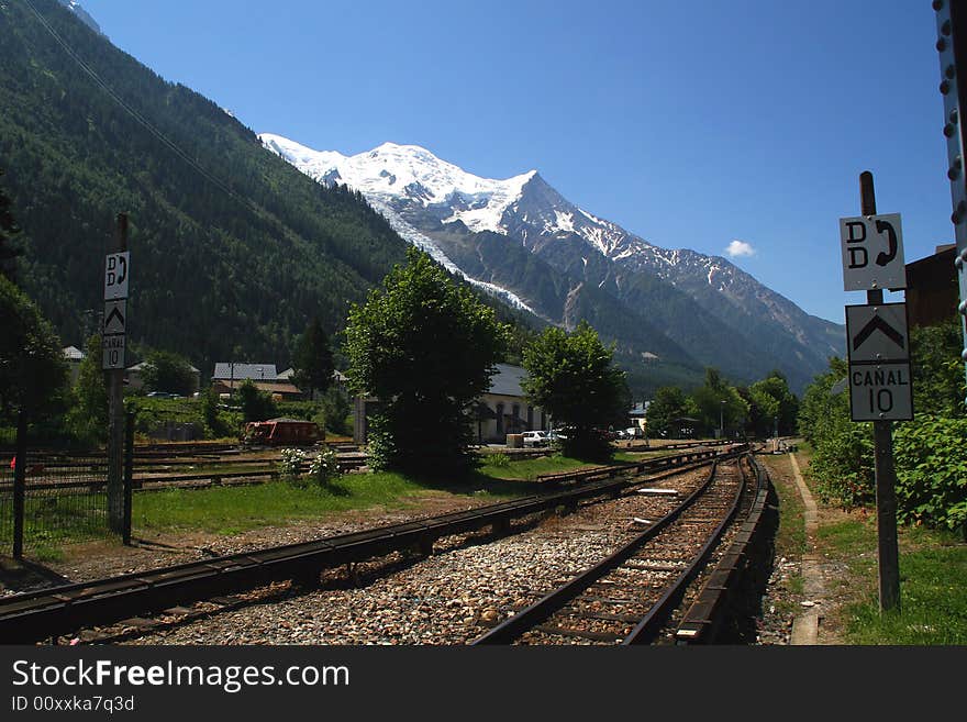 Train station in a valley in Europe at the base of the alps