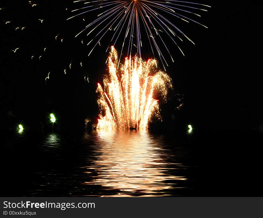 Fireworks reflected in water background