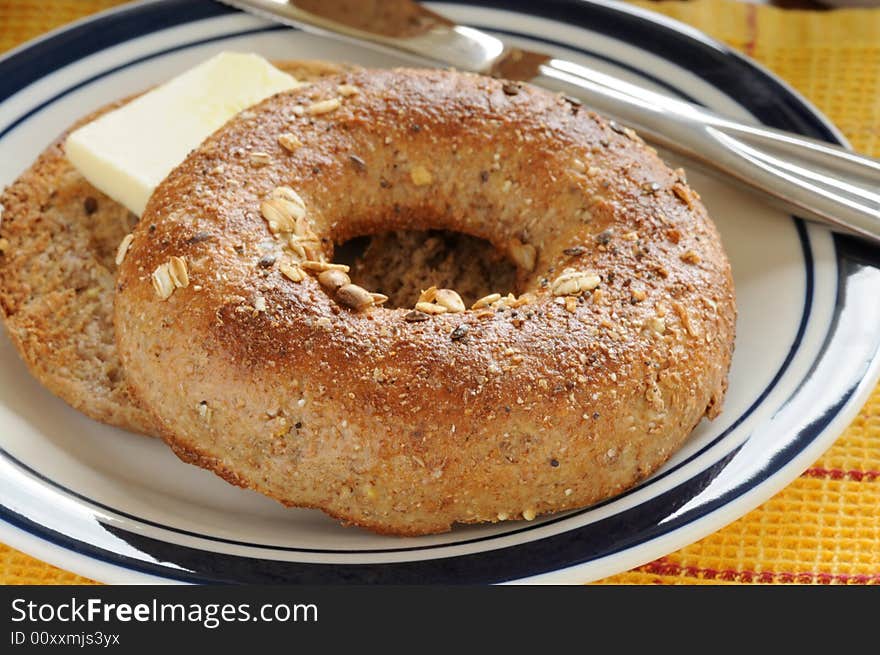 Toasted whole grain bagel with butter sliced.