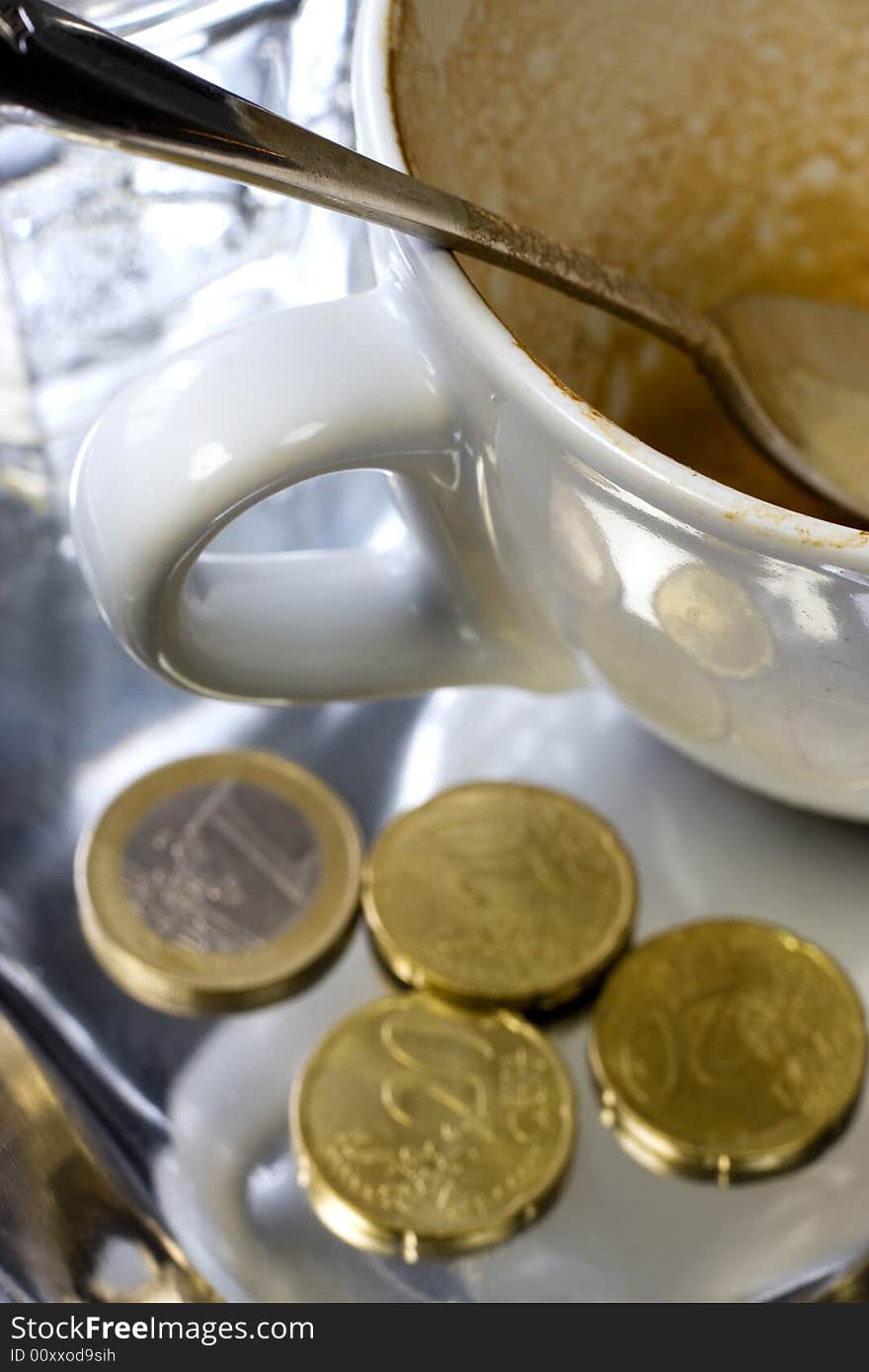 Empty coffee cup with Euro coins