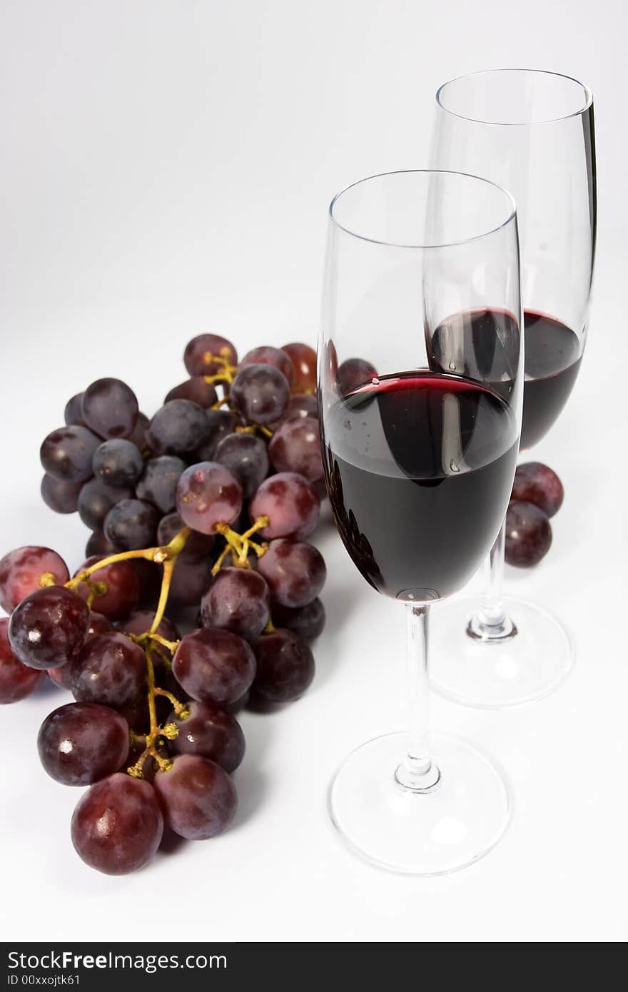 Glasses of red wine with grapes. Glasses of red wine with grapes