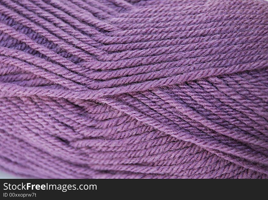 Close up lilac yarn ball for handicraft projects like crochet and knitting. Close up lilac yarn ball for handicraft projects like crochet and knitting.