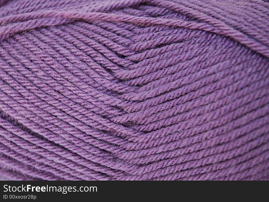 Close up lilac yarn ball for handicraft projects like crochet and knitting. Close up lilac yarn ball for handicraft projects like crochet and knitting.