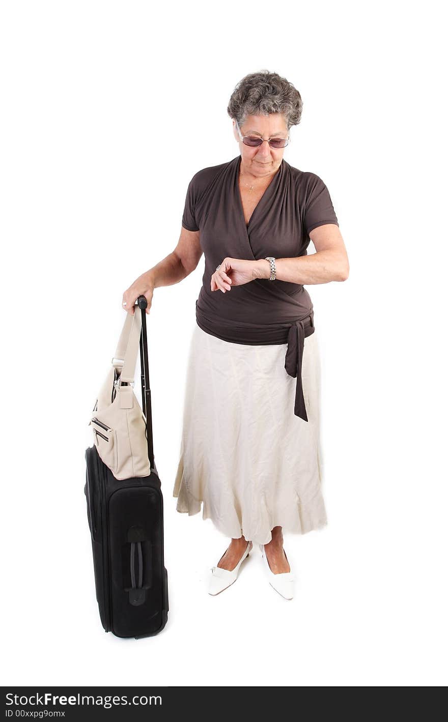 Retired lady traveler with suitcase - over white. Retired lady traveler with suitcase - over white