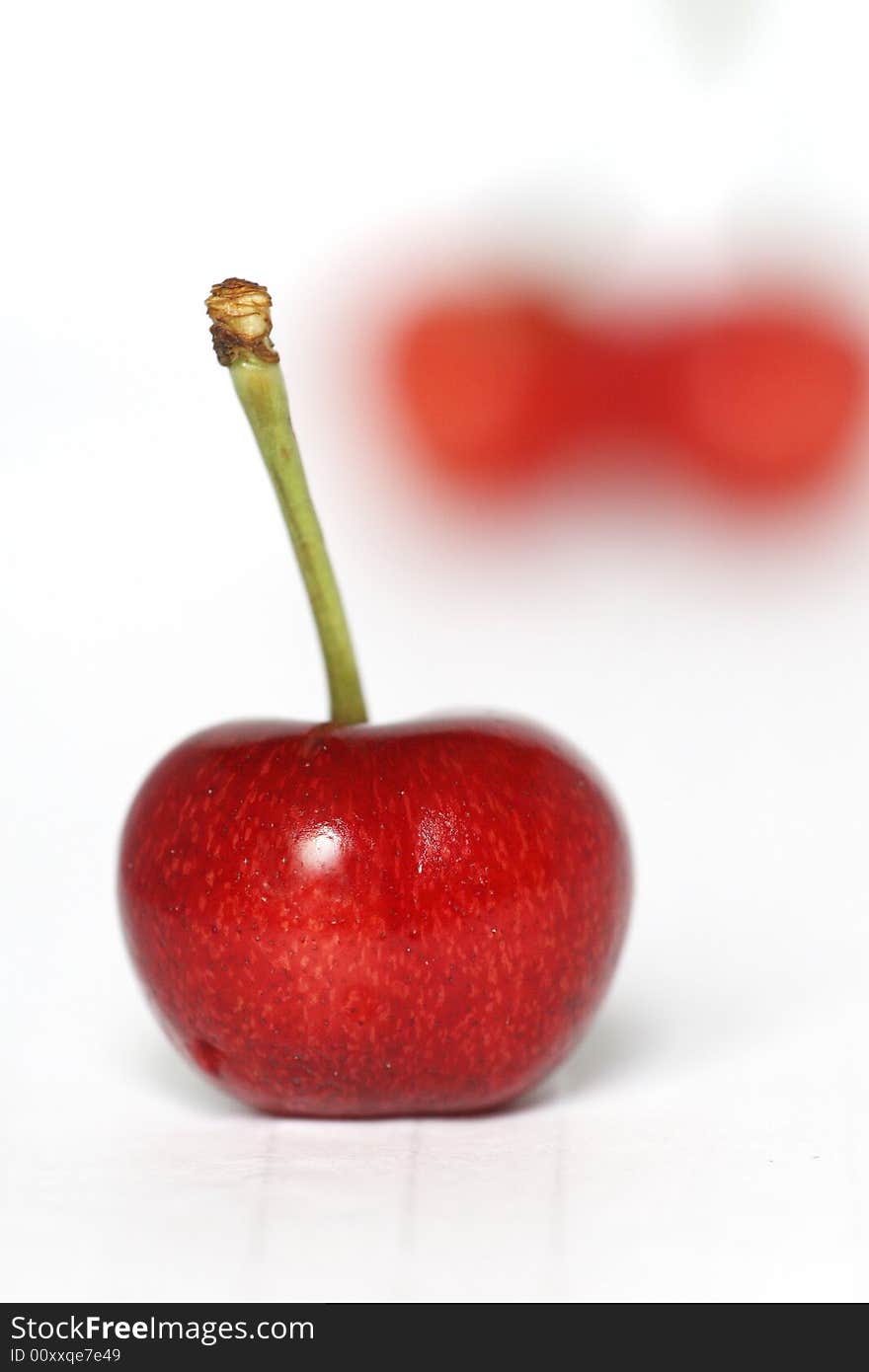 Red cherry in white background.